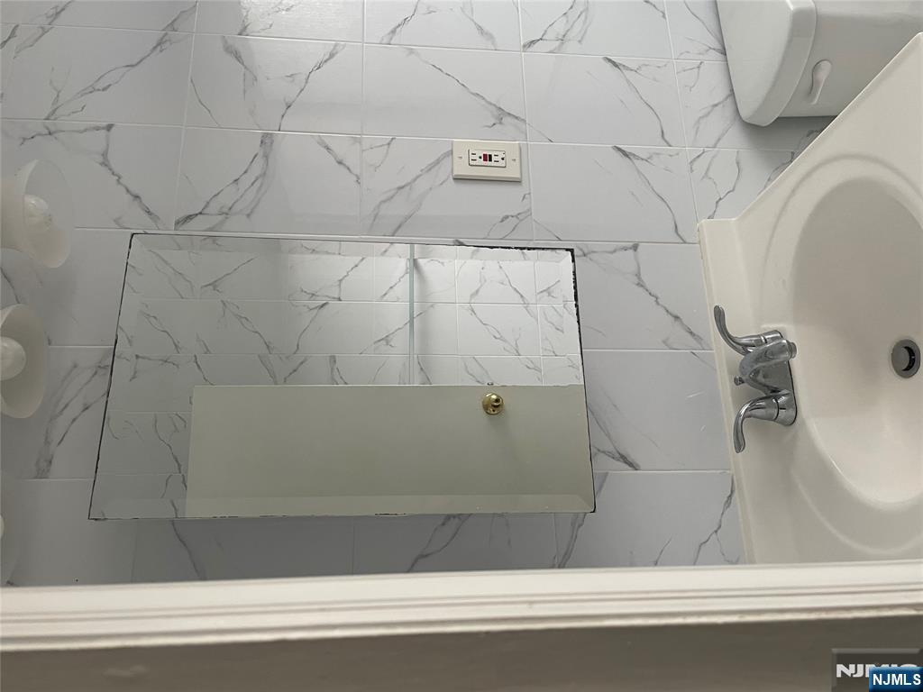 232-230 Anderson Avenue, Unit 3A Fairview, NJ 07022 - Photo 10 of 11 a bathroom with a sink and a toilet