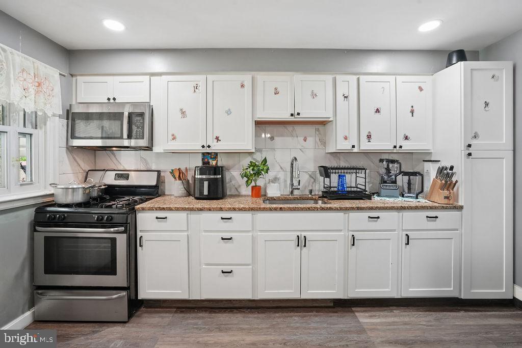 1918 Church Road Baltimore, MD 21222 - Photo 6 of 29 a kitchen with stainless steel appliances granite countertop a sink a stove and a refrigerator