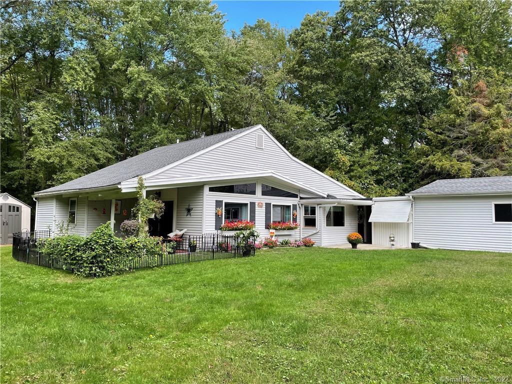 a front view of house with a garden