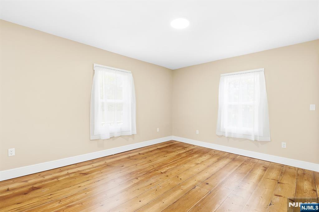 36 Pascack Road, Unit 2 Park Ridge, NJ 07656 - Photo 11 of 22 an empty room with wooden floor and windows
