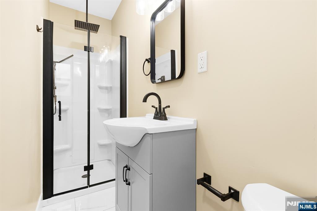 36 Pascack Road, Unit 2 Park Ridge, NJ 07656 - Photo 13 of 22 a bathroom with a sink and mirror