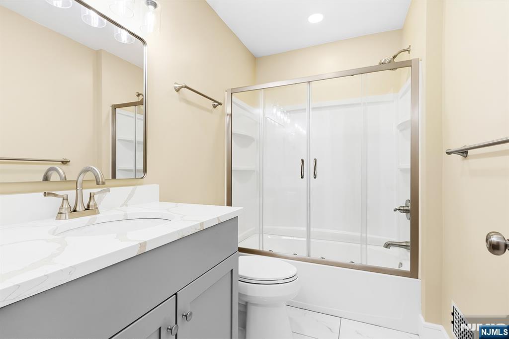 36 Pascack Road, Unit 2 Park Ridge, NJ 07656 - Photo 15 of 22 a bathroom with a shower sink vanity mirror and toilet