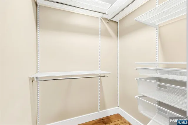 a view of walk in closet with empty racks