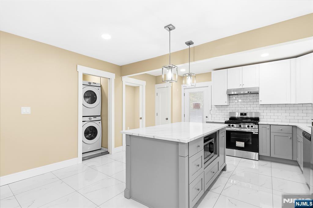 36 Pascack Road, Unit 2 Park Ridge, NJ 07656 - Photo 3 of 22 a kitchen with stainless steel appliances granite countertop a stove and a refrigerator
