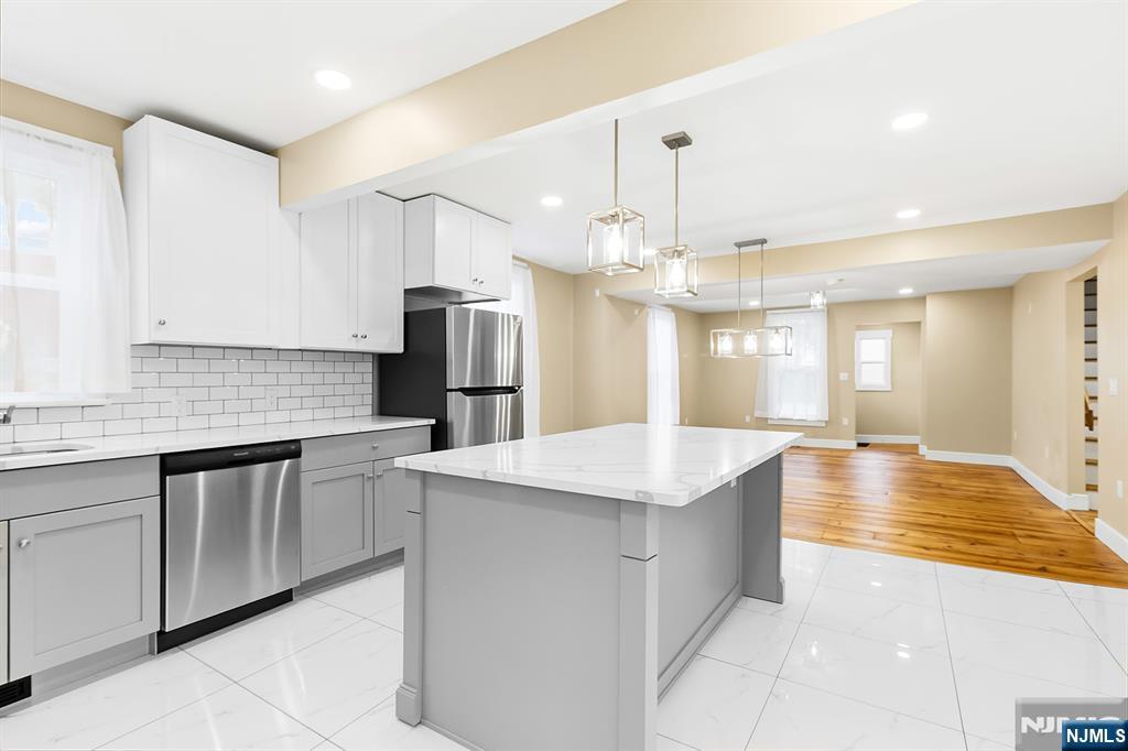 36 Pascack Road, Unit 2 Park Ridge, NJ 07656 - Photo 5 of 22 a large kitchen with kitchen island a sink stainless steel appliances and cabinets