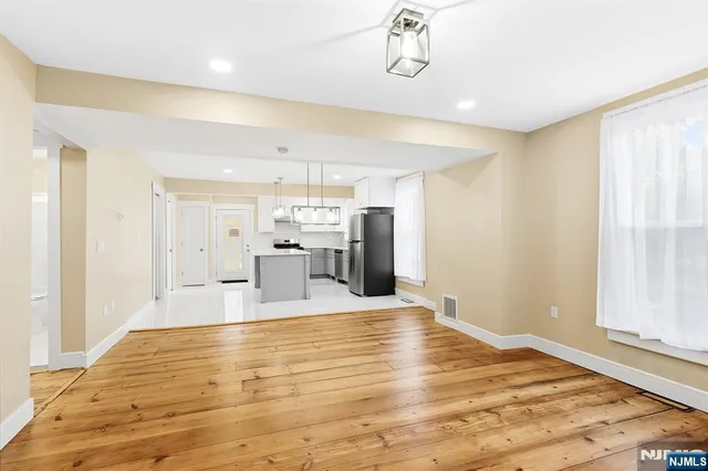 a view of a kitchen with wooden floor