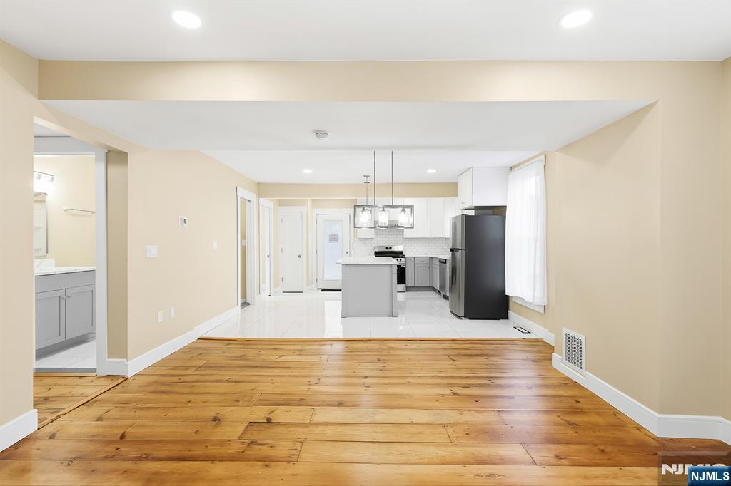 36 Pascack Road, Unit 2 Park Ridge, NJ 07656 - Photo 7 of 22 a large kitchen with kitchen island a sink stainless steel appliances and cabinets