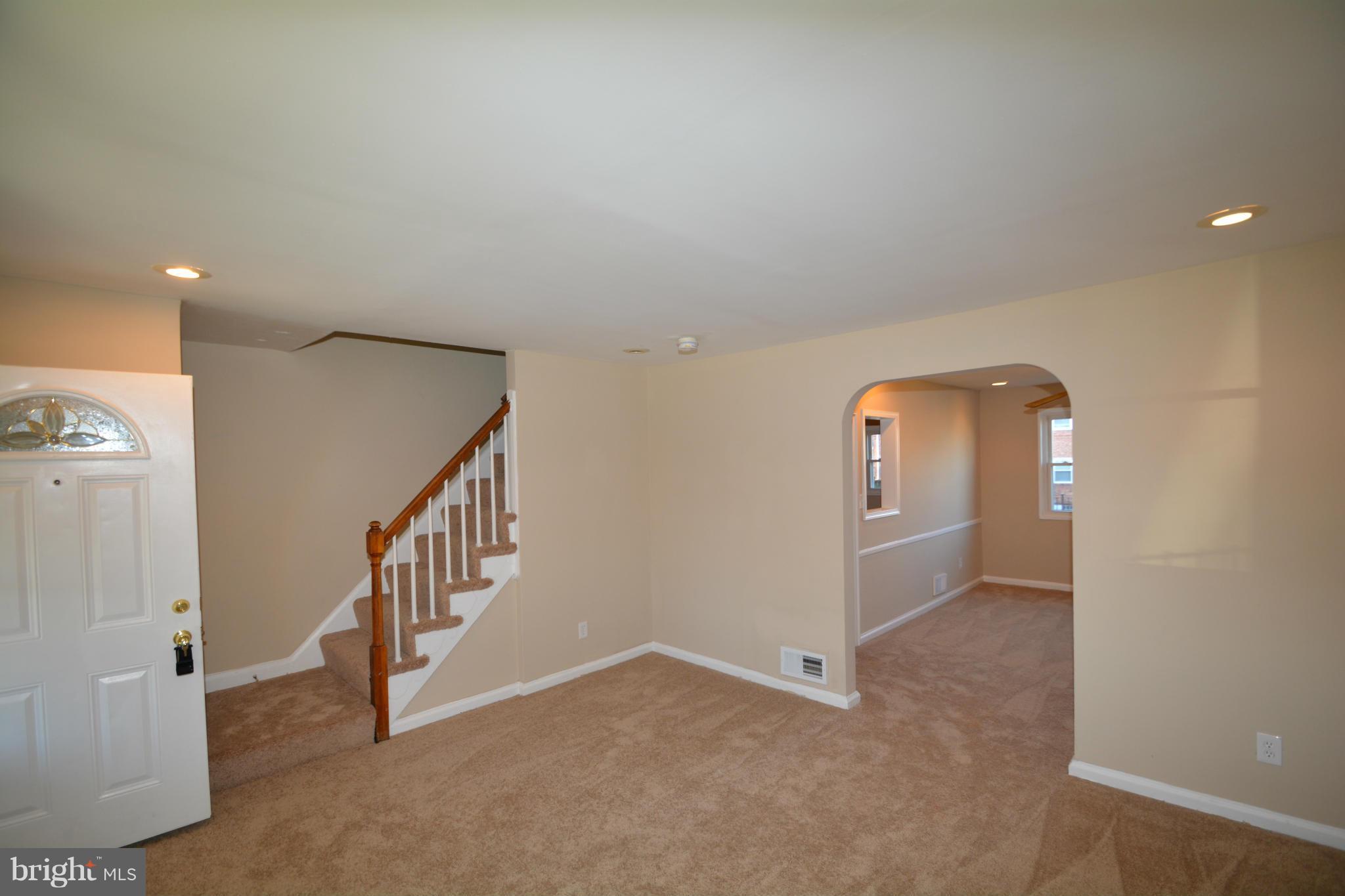 5454 Whitlock Road Baltimore, MD 21229 - Photo 12 of 30 en empty room with stairs and white walls