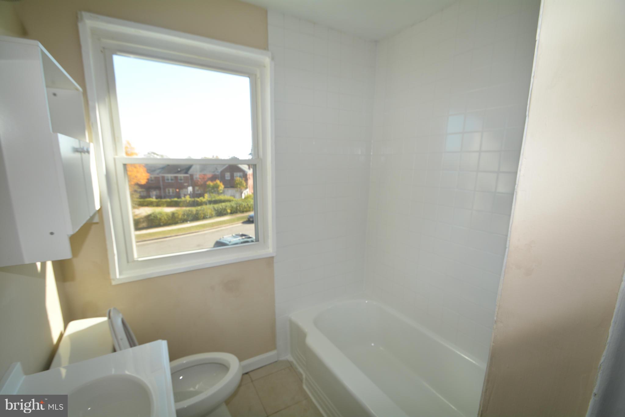 5454 Whitlock Road Baltimore, MD 21229 - Photo 14 of 30 a bathroom with a bathtub and window