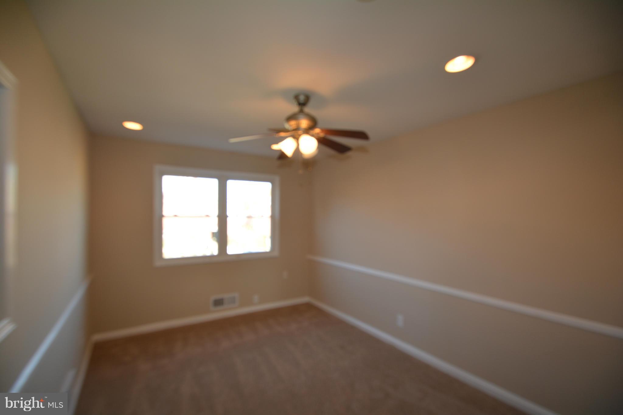 5454 Whitlock Road Baltimore, MD 21229 - Photo 20 of 30 an empty room with a window and a chandelier fan
