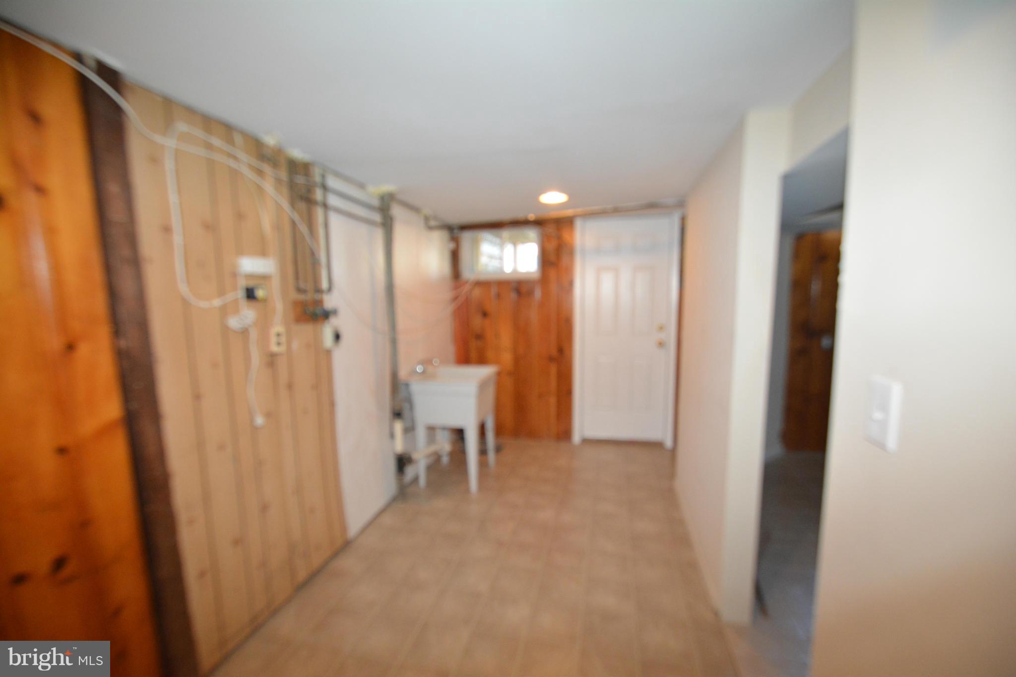 5454 Whitlock Road Baltimore, MD 21229 - Photo 25 of 30 a view of a bathroom with a shower and a sink