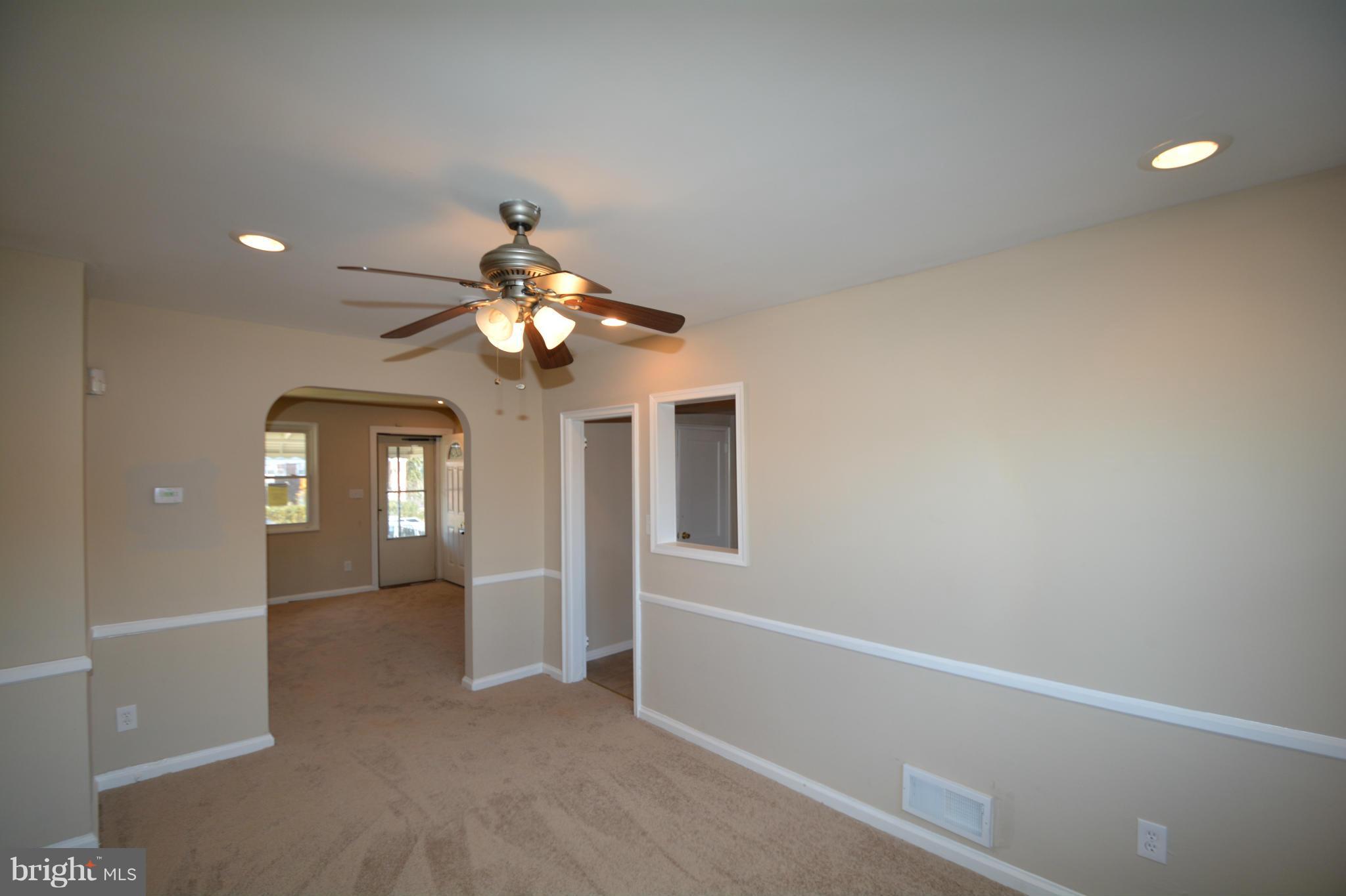 5454 Whitlock Road Baltimore, MD 21229 - Photo 4 of 30 wooden floor in an empty room with a window