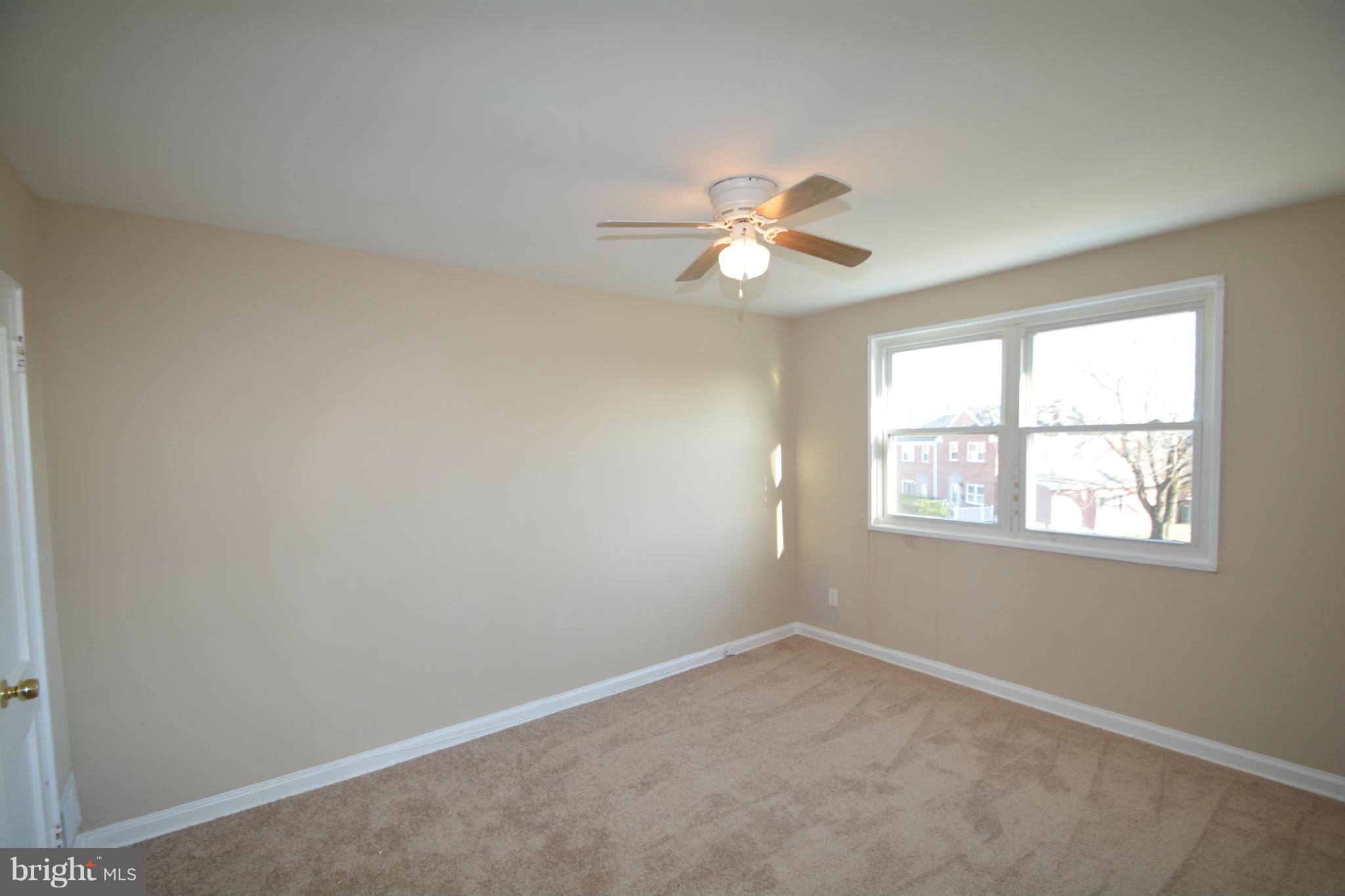 5454 Whitlock Road Baltimore, MD 21229 - Photo 8 of 30 an empty room with a window and a ceiling fan
