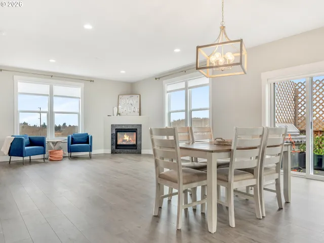 a view of a livingroom with furniture a fireplace and wooden floor
