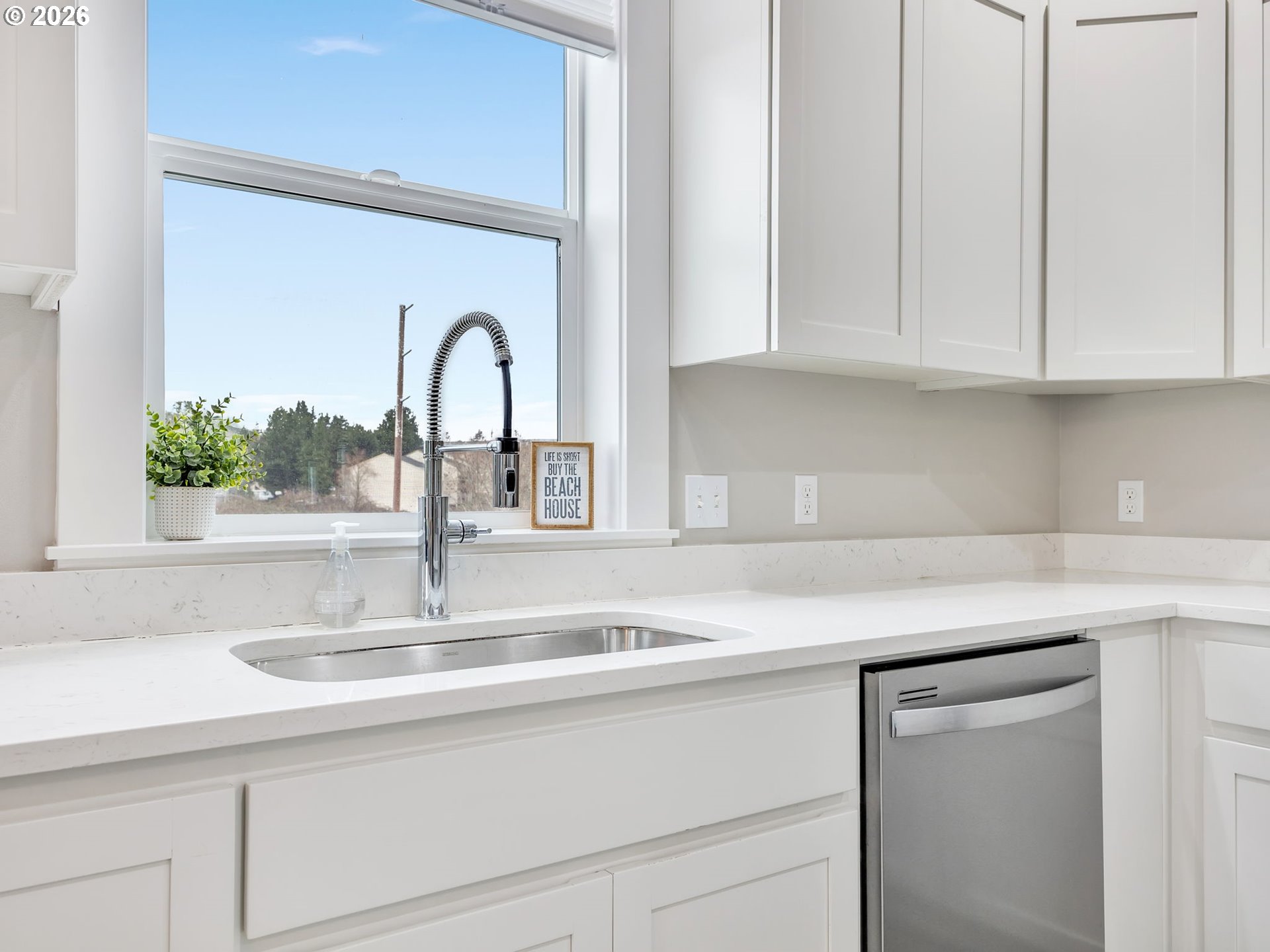 2188 Stanley Lake Court Seaside, OR 97138 - Photo 17 of 46 a kitchen with granite countertop white cabinets and a sink