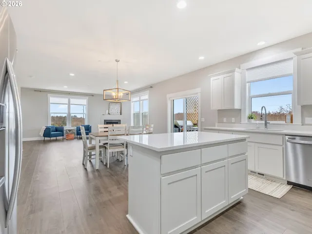a kitchen with white cabinets and sink