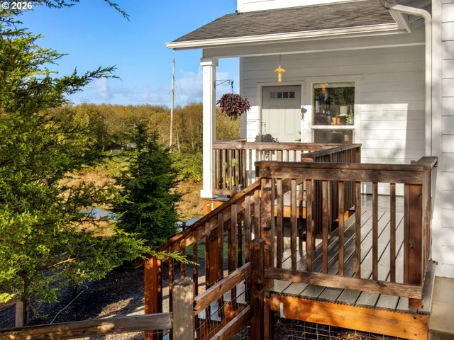 a view of balcony with wooden floor and fence