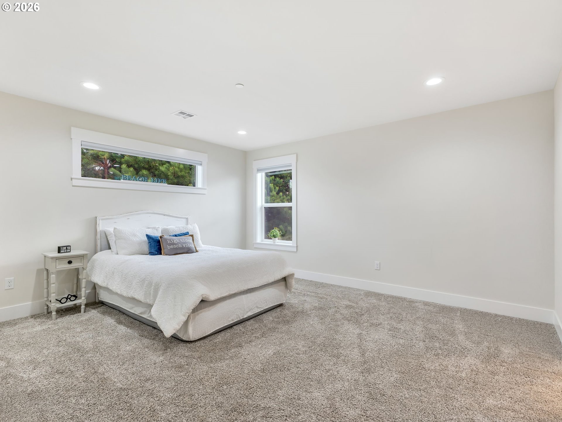 2188 Stanley Lake Court Seaside, OR 97138 - Photo 25 of 46 a spacious bedroom with a bed and a large window