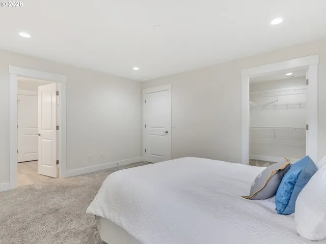 a bedroom with a bed and a night stand