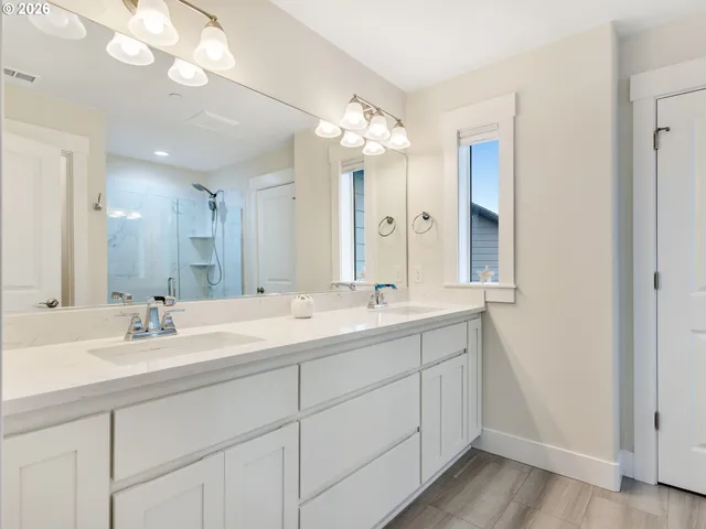 a bathroom with a double vanity sink and a mirror