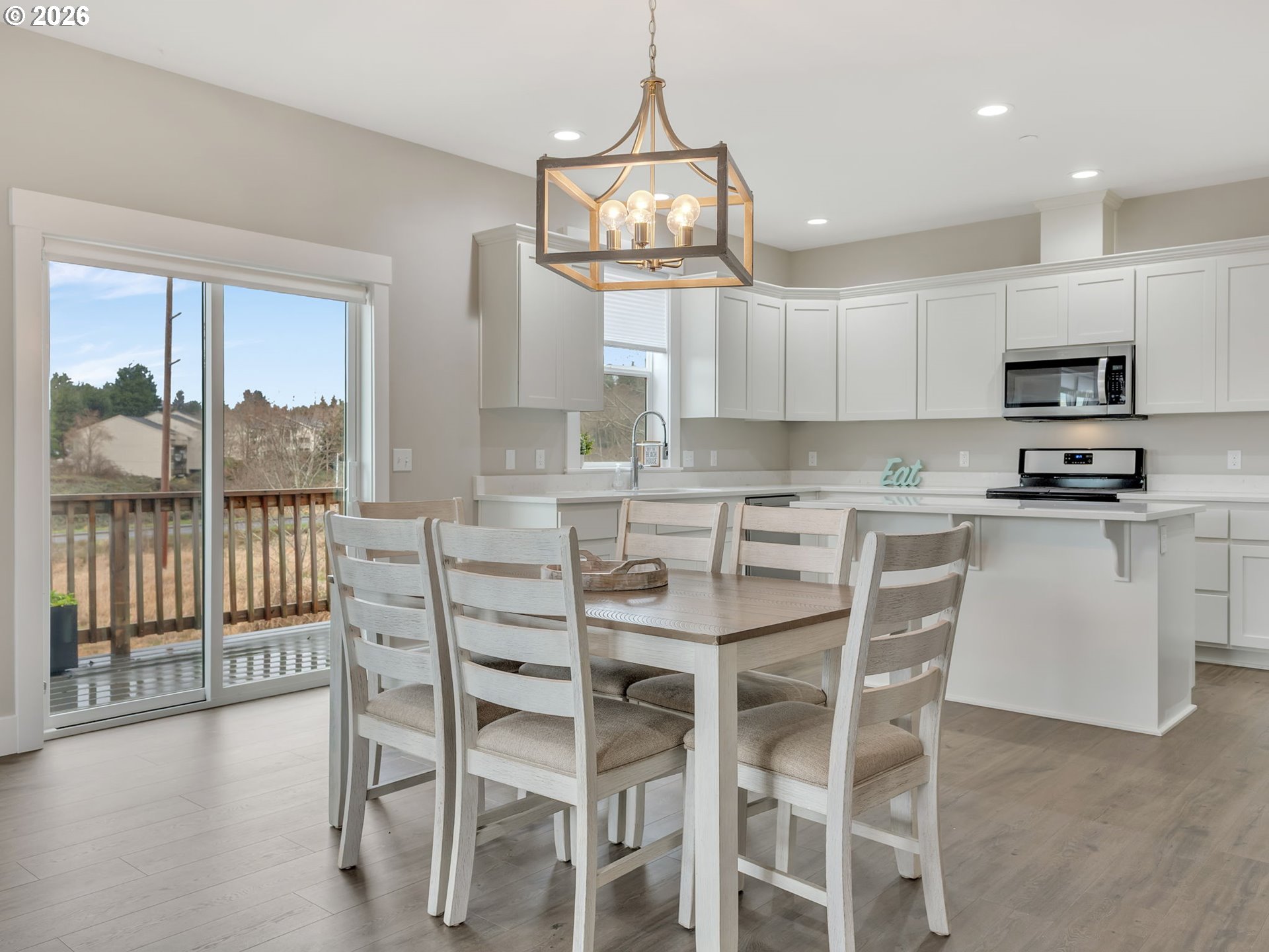 2188 Stanley Lake Court Seaside, OR 97138 - Photo 10 of 46 a kitchen with a dining table chairs wooden floor and appliances