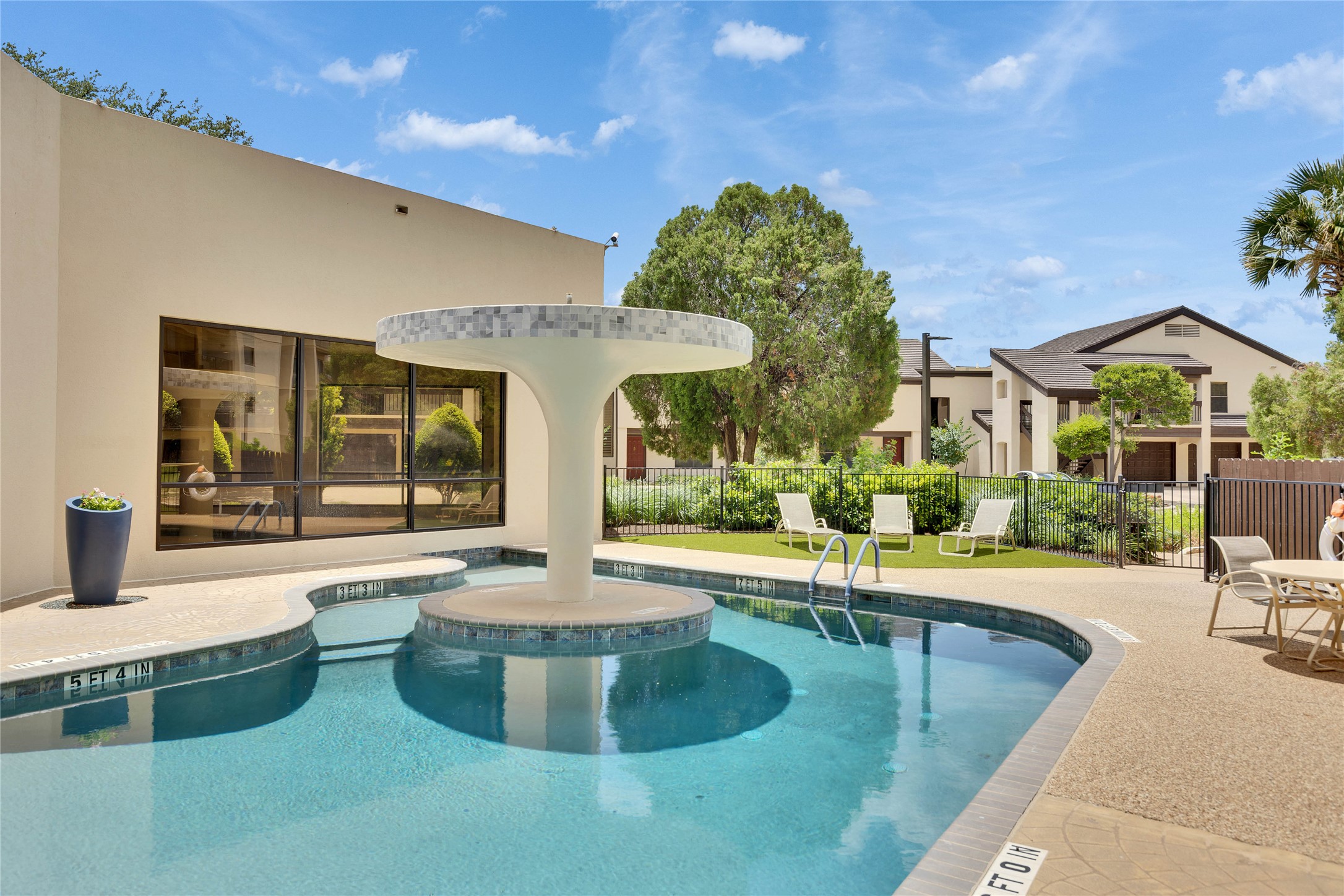 40 North Interstate Highway 35, Unit 7B1 Austin, TX 78701 - Photo 16 of 21 A pristine community pool framed by inviting lounge areas and verdant landscaping.