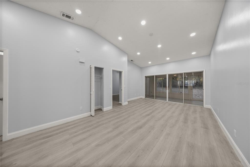 10441 Southwest 85th Court Ocala, FL 34481 - Photo 16 of 32 an empty room with wooden floor and windows