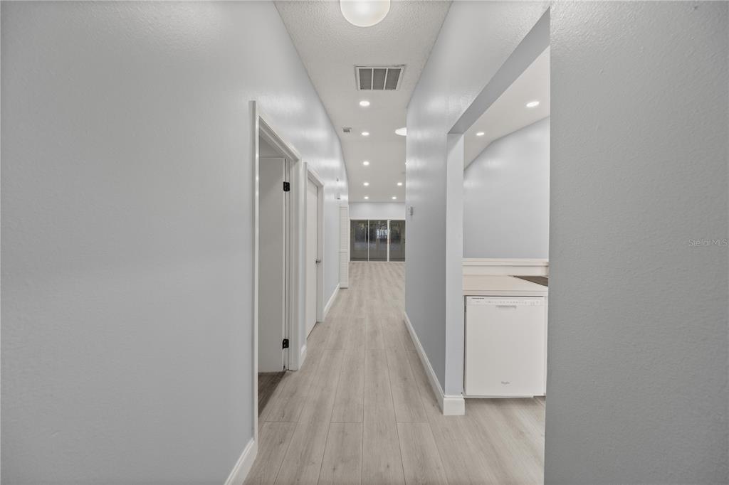 10441 Southwest 85th Court Ocala, FL 34481 - Photo 5 of 32 a view of a hallway with wooden floor