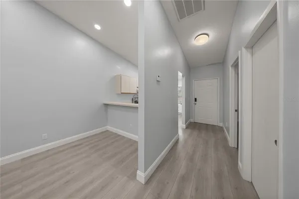 a view of a hallway with wooden floor