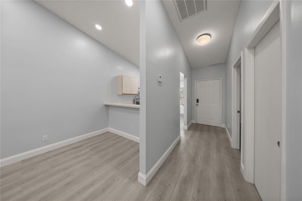 10441 Southwest 85th Court Ocala, FL 34481 - Photo 6 of 32 a view of a hallway with wooden floor