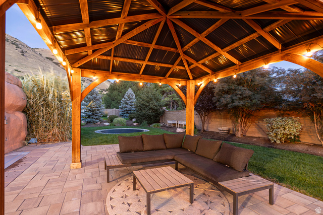 687 South 2080th Street East Springville, UT 84663 - Photo 148 of 149 Expansive outdoor patio featuring a wooden gazebo with a corrugated metal roof, string lighting, and a patterned paver surface