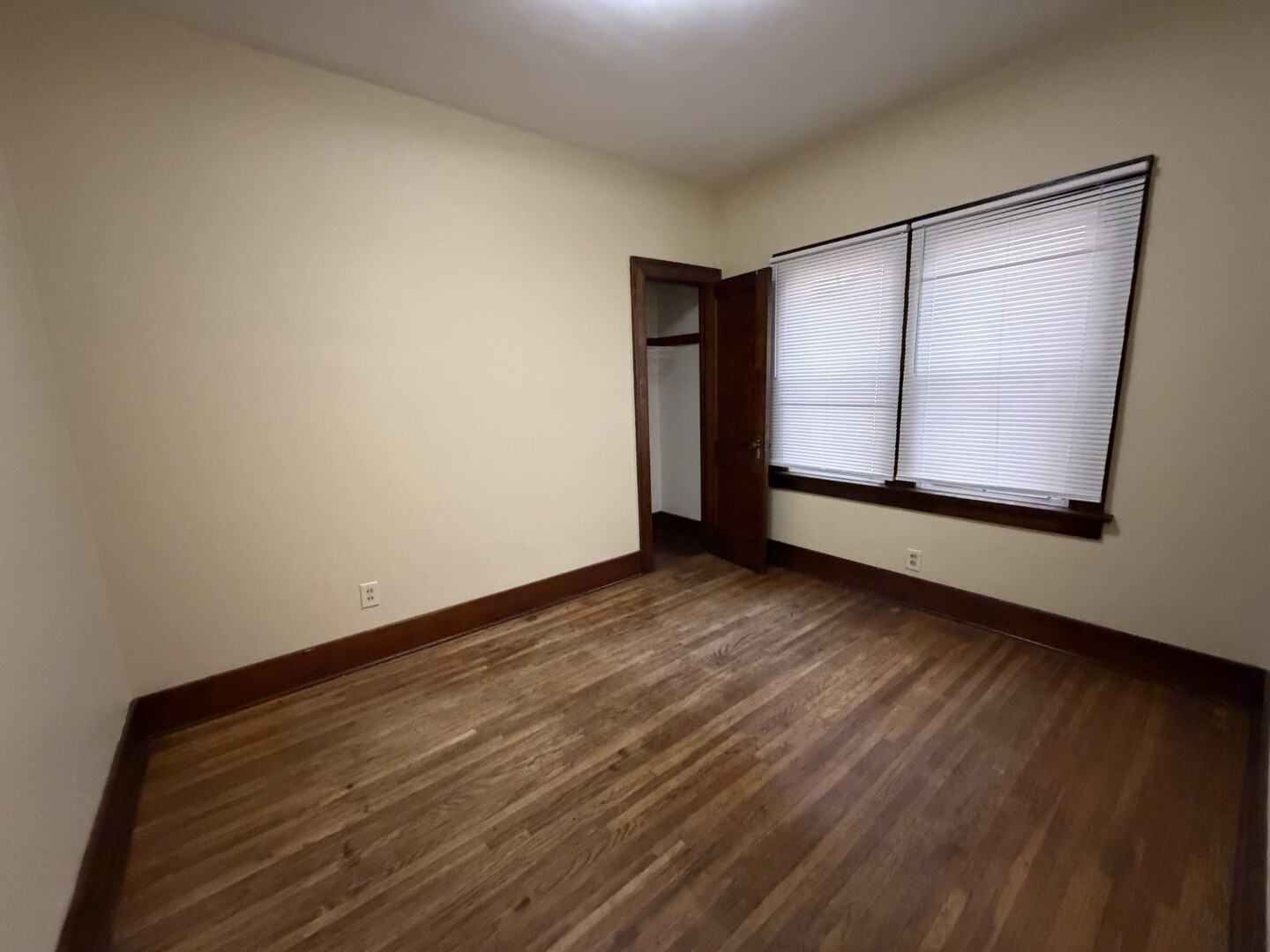 705 West Olive Street Bloomington, IL 61701 - Photo 12 of 32 a view of an empty room with wooden floor and a window