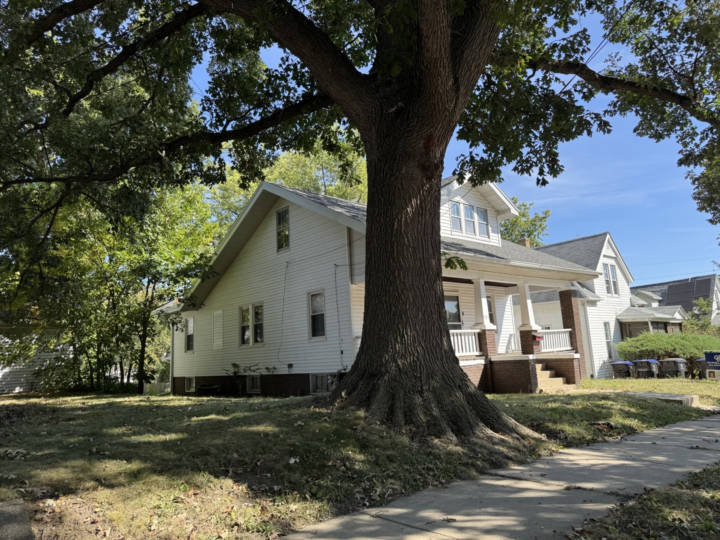 705 West Olive Street Bloomington, IL 61701 - Photo 3 of 32 a view of a white house next to a yard with a tree