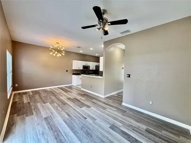 a view of a kitchen with a sink and a refrigerator