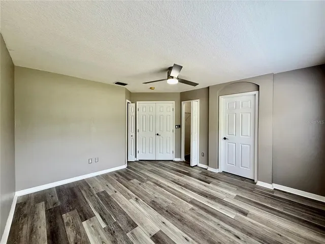 a view of a livingroom with wooden floor and windows