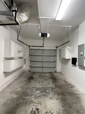 a kitchen with cabinets and white walls