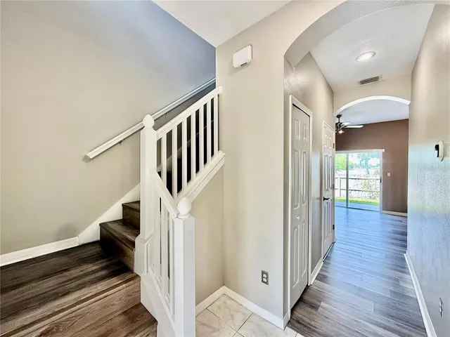 a view of entryway and hall with wooden floor