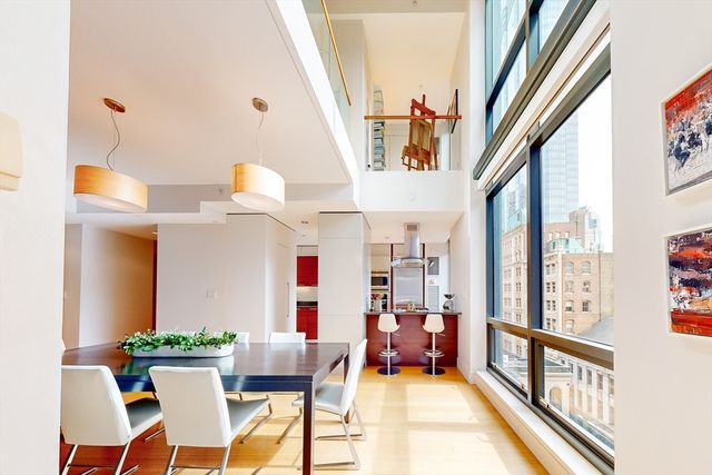 a very nice looking room with a large window and furniture