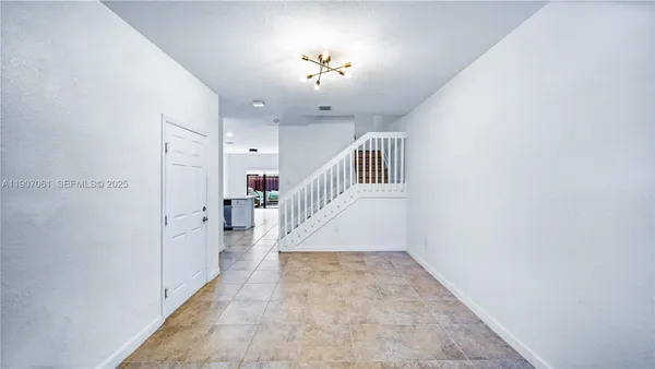 a view of entryway and hall with a front door