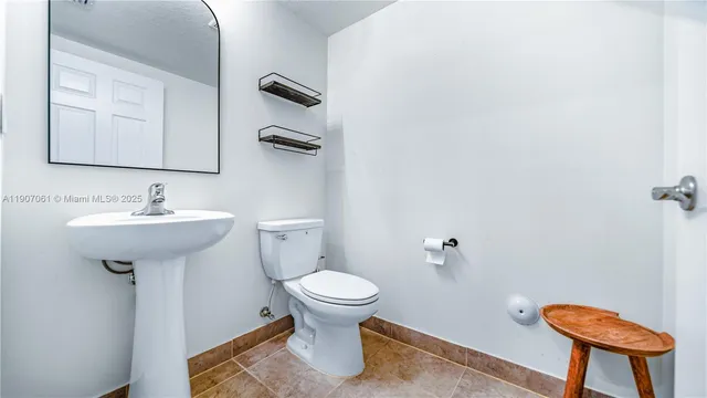 an empty room with a window and a ceiling fan