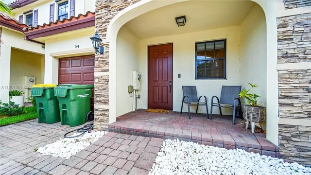 a view of front door of house with potted plant