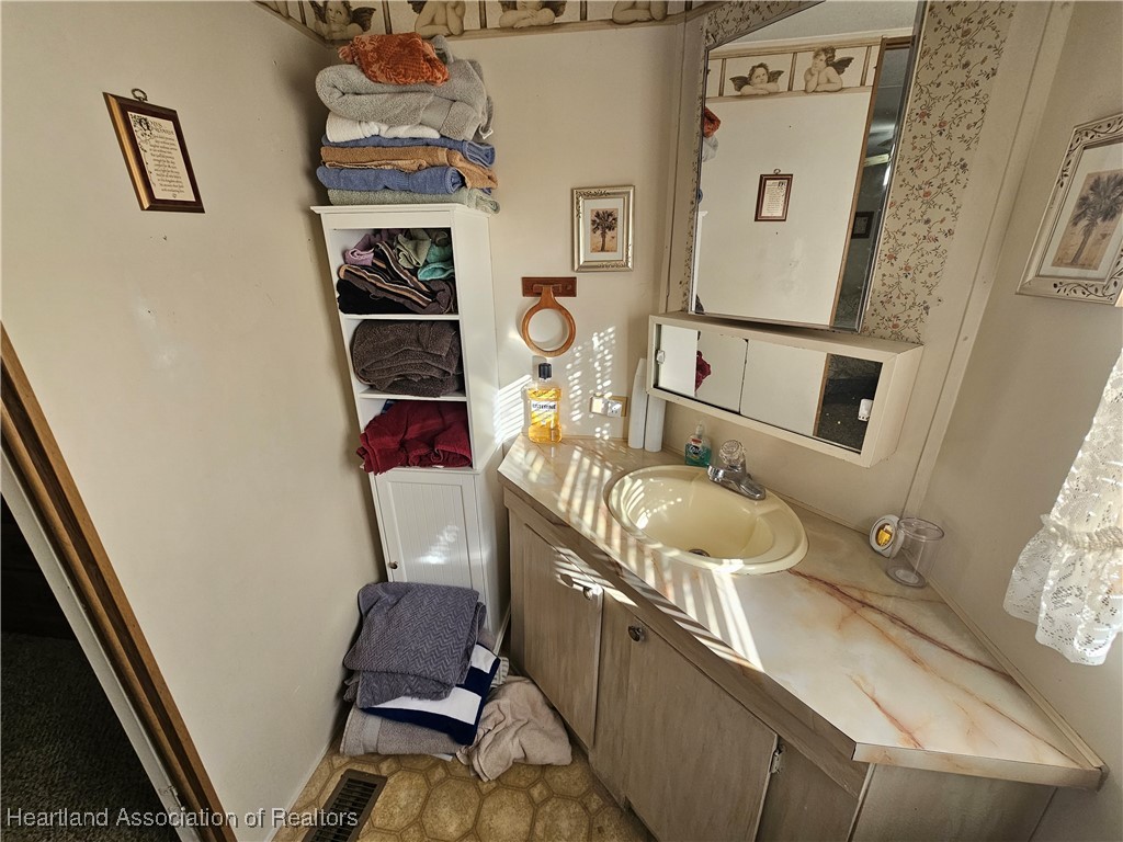 7959 Elliott Road Sebring, FL 33876 - Photo 12 of 31 a bathroom with a sink toilet and mirror