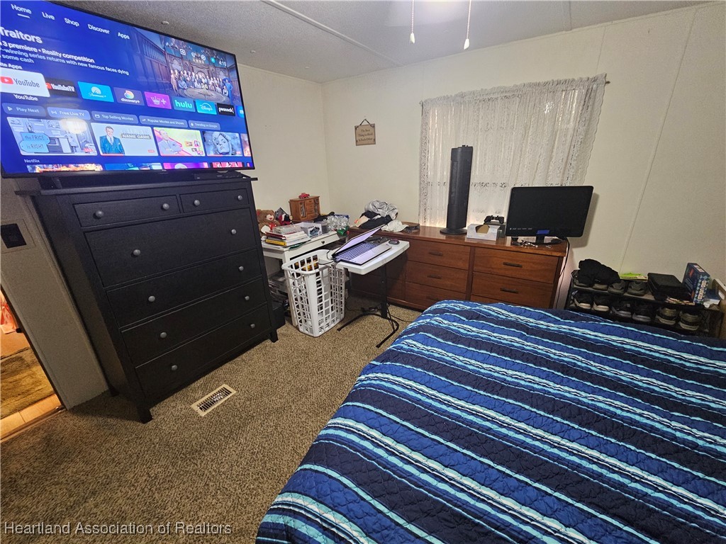 7959 Elliott Road Sebring, FL 33876 - Photo 22 of 31 a room with wooden floor and furniture