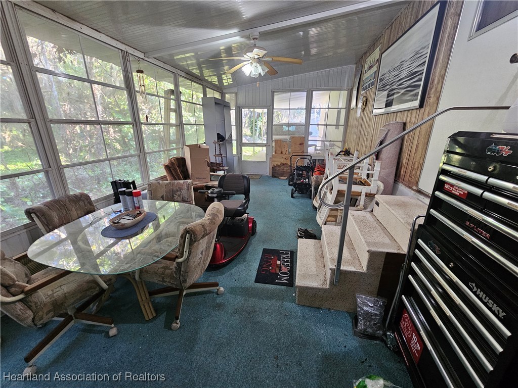 7959 Elliott Road Sebring, FL 33876 - Photo 23 of 31 a living room with furniture and a floor to ceiling window