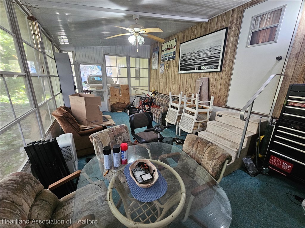 7959 Elliott Road Sebring, FL 33876 - Photo 24 of 31 a living room with furniture and a floor to ceiling window