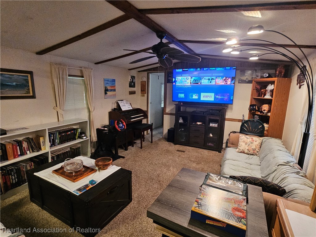 7959 Elliott Road Sebring, FL 33876 - Photo 7 of 31 a living room with furniture and a flat screen tv