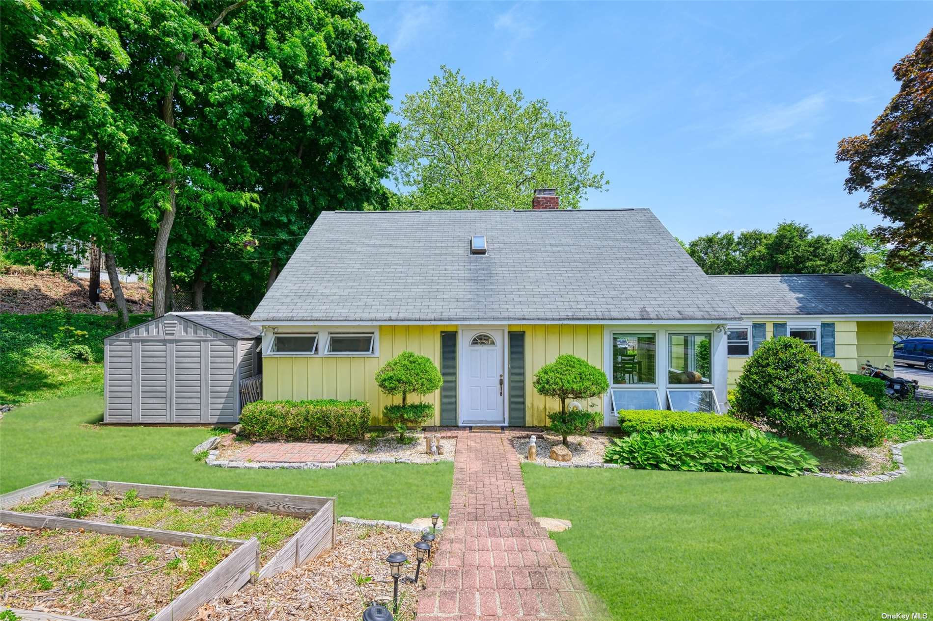 a view of a house with garden and yard