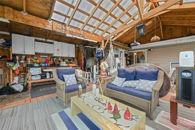 a view of a living room with furniture and a kitchen view