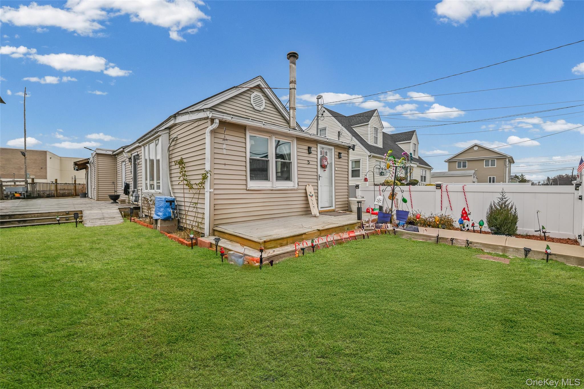 5 Chestnut Road Inwood, NY 11096 - Photo 3 of 20 a front view of a house with garden and porch