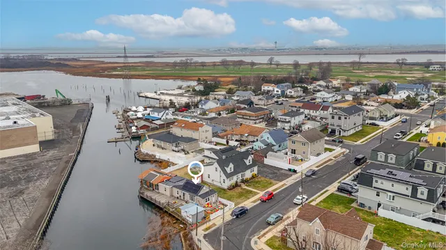 an aerial view of a house with a lake